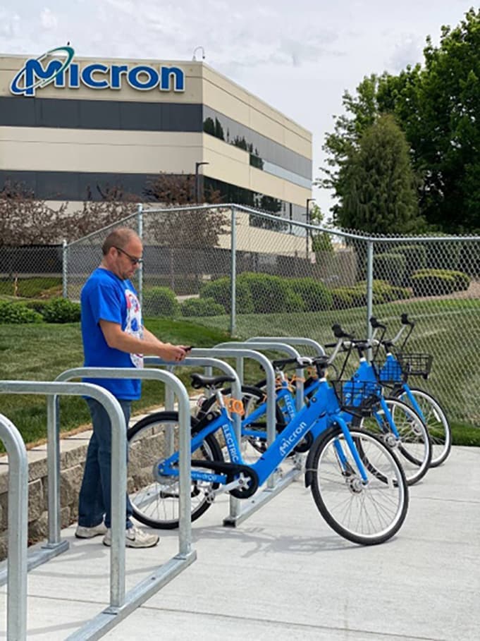 Blue Butterfly bike share bicycles parked at a Micron campus rack