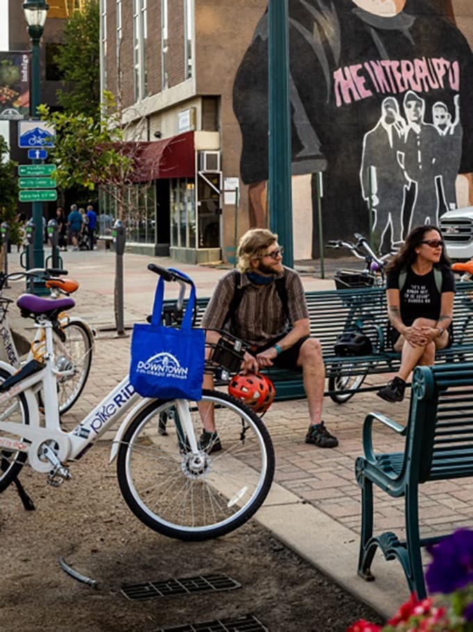 Butterfly bike share bicycles parked on a downtown street